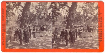 Stockton: (Stockton Guard. Group of uniformed men in front of refreshment stand at unidentified summer outing, probably Stockton Guard at Good Water Grove)