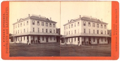 Stockton: (Large three story building with men in front.)