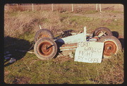 JAN75P4-19: car sculpture, FORD WORKERS FIGHT LAY-OFFS sign