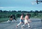 [Jonestown basketball game, children playing]