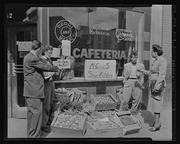 Small group standing in front of M. C. and S. Soup Kitchen, California Labor School