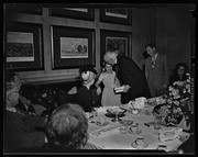 Dean of Canterbury hugging girl at luncheon, California Labor School