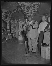 Man singing and playing guitar, California Labor School