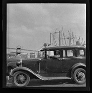 Man driving car along waterfront, California Labor School