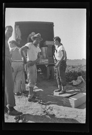 Workers standing by truck in field, California Labor School