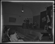 Vincente Lombardo Toledano and two other men on stage, California Labor School