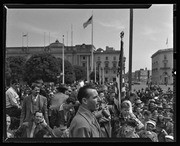 Man speaking at microphone among crowd at parade, San Francisco, Calif., California Labor School