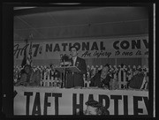 Man at microphone and panel speakers at FTA 7th National Convention, California Labor School