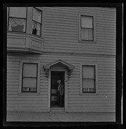 Man standing in doorway of house, California Labor School