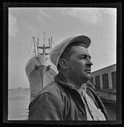 Man wearing cap on waterfront dock, California Labor School