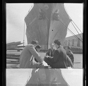 Men sitting in front of docked ship, Hawaiian Rancher, California Labor School