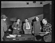 David Jenkins and group of men standing around table at California Labor School Cultural Conference