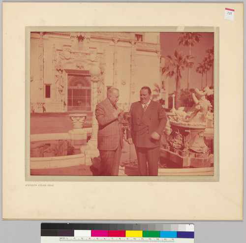 William Randolph and George Hearst with dog, standing by fountain at Hearst Castle