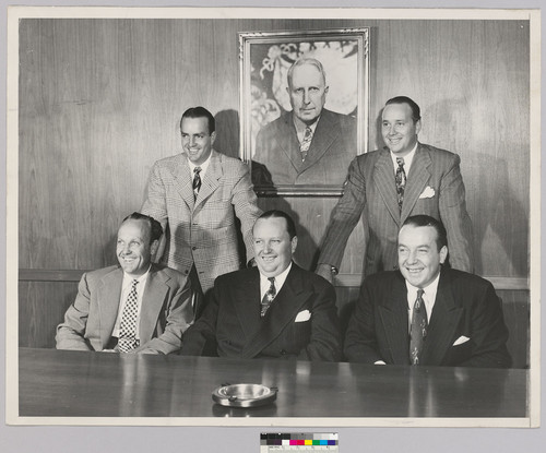 Hearst brothers with portrait of William Randolph Hearst, Sr