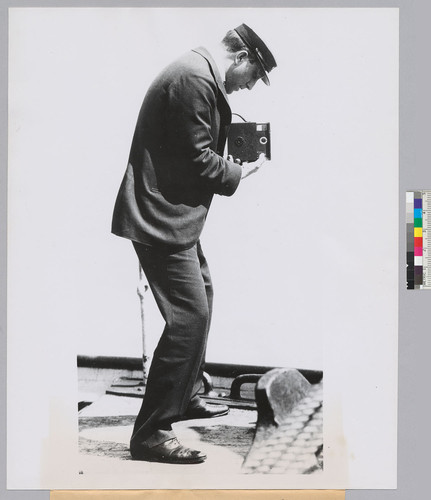 William Randolph Hearst, Sr. taking a photograph from his yacht