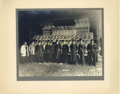 Chapman at an Erie Pier citrus crate display of P. Rulhman & Co., New York receivers of Old Mission Brand fruit