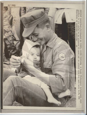 South Vietnamese Soldier Holds his Child