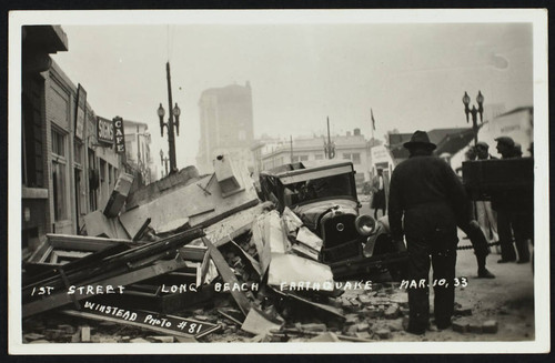 1st St. with building debris fallen on a car, damage from the 1933 earthquake