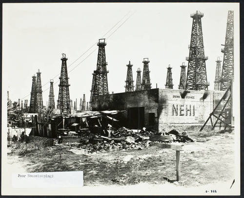 Abandoned industrial building (damaged by fire ?) in front of an oil field