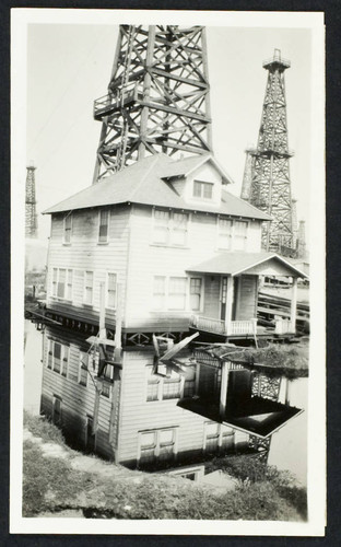 An abandoned house surrounded by a lake of oil