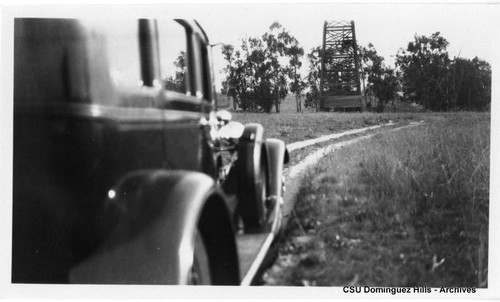 Car approaching oil well