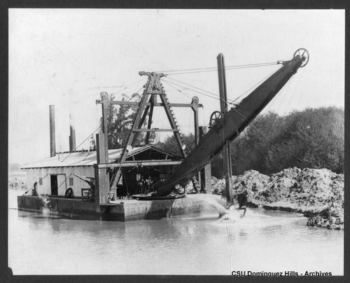 Dredging flooded land near Los Angeles River