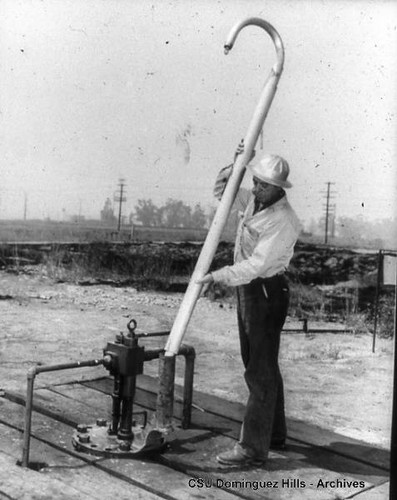 Oil worker with hook-like tool