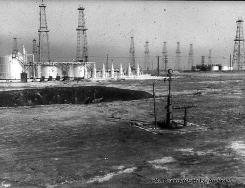 Oil wells with storage tanks