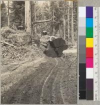 Redwood Region. Large and heavy redwood butt approaching truck loading landing. Same log pictured in #6887-8. 6-11-41. E.F