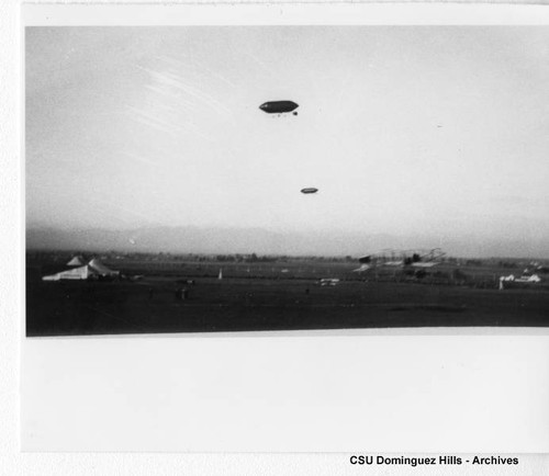 Curtiss Biplane and dirigibles in flight