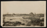 Flooded land with barn and house