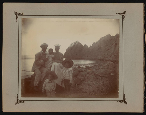 Rozelle family poses by rocks on Catalina Island