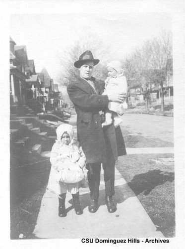 Man with two small children in coats and hats