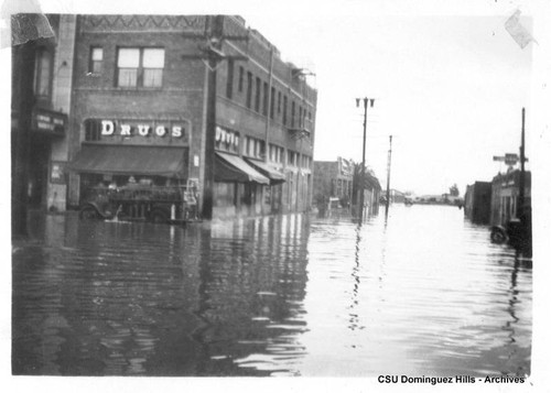 Hose truck in front of drugstore