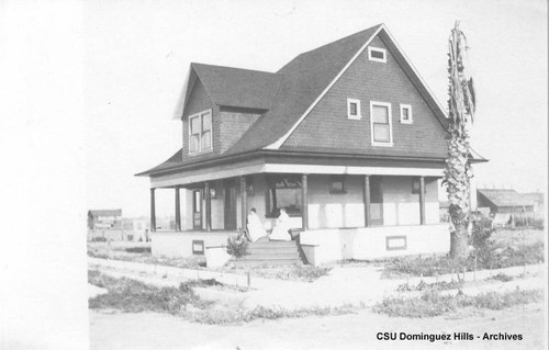 Black house in Compton with women on the porch