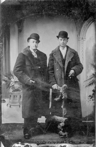 Two young men in coats and hats