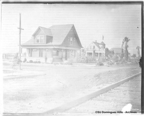 Black house, rail tracks in foreground