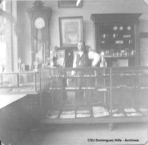 Man behind jewelry counter at store