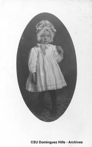 Young child in dress and bonnet