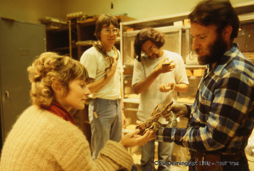 Biology instructor with students and reptiles