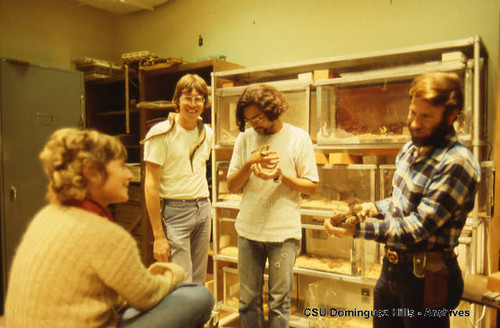 Biology instructor with students and reptiles