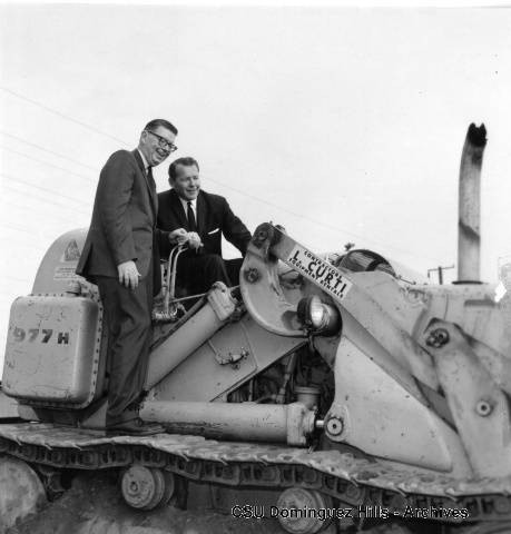 President Cain and Lieutenant Governor Robert Finch on bulldozer