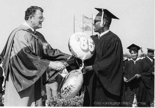 President Butwell congratulating graduate