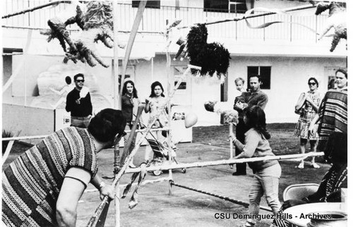 Students play with pinata at Spanish Club booth during Club Day