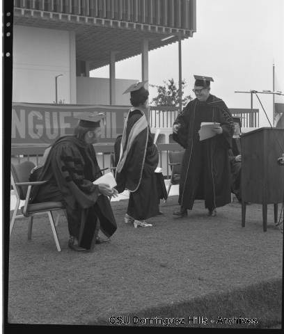 President Cain congratulating Dr. Chi