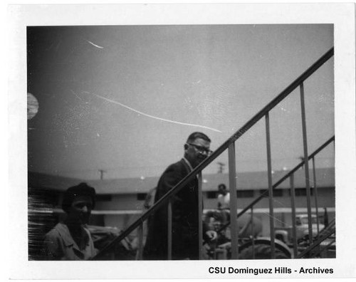 President Cain on stairs during Watt Campus Construction