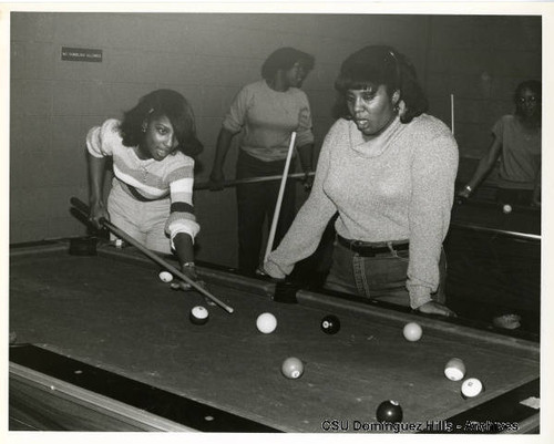 Female students play billiards in Small College Student Union