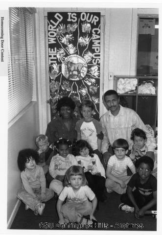 Teachers with children in front of decorated door