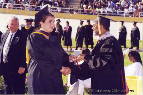 Arts and Sciences gradaute receiving diploma