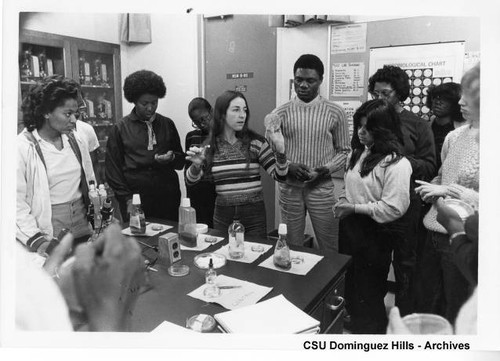 Biology professor with students in lab